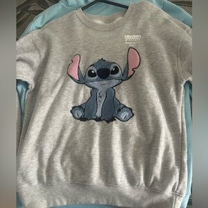 A Stitch sweater, is like brand new very cute for a trip or take to Disney.